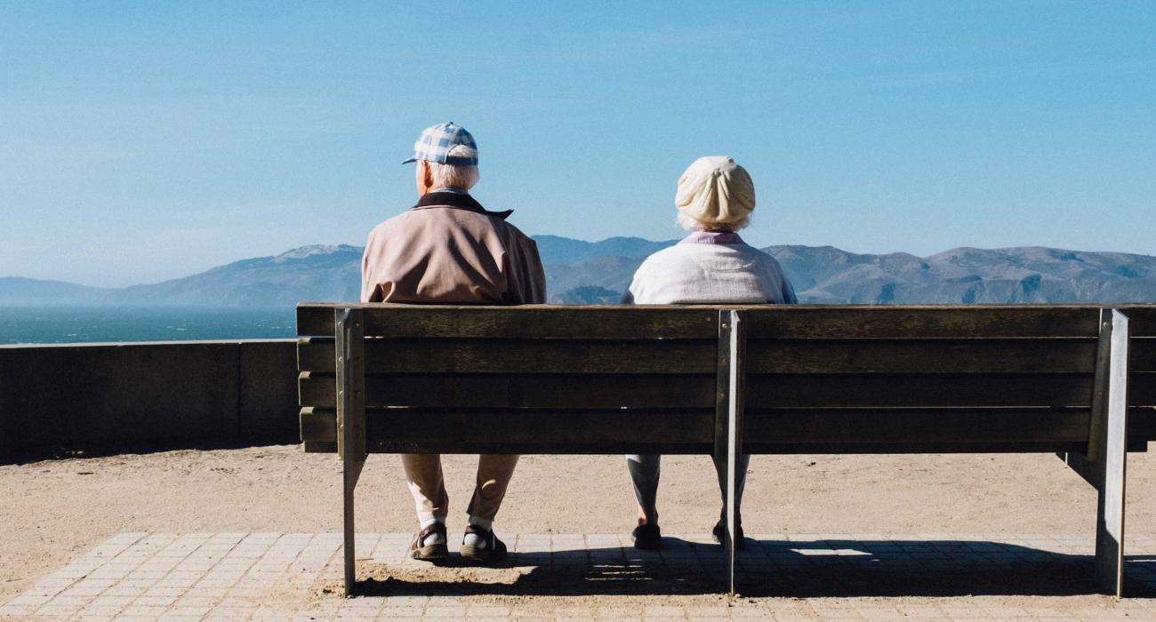Elderly couple on bench at overlook